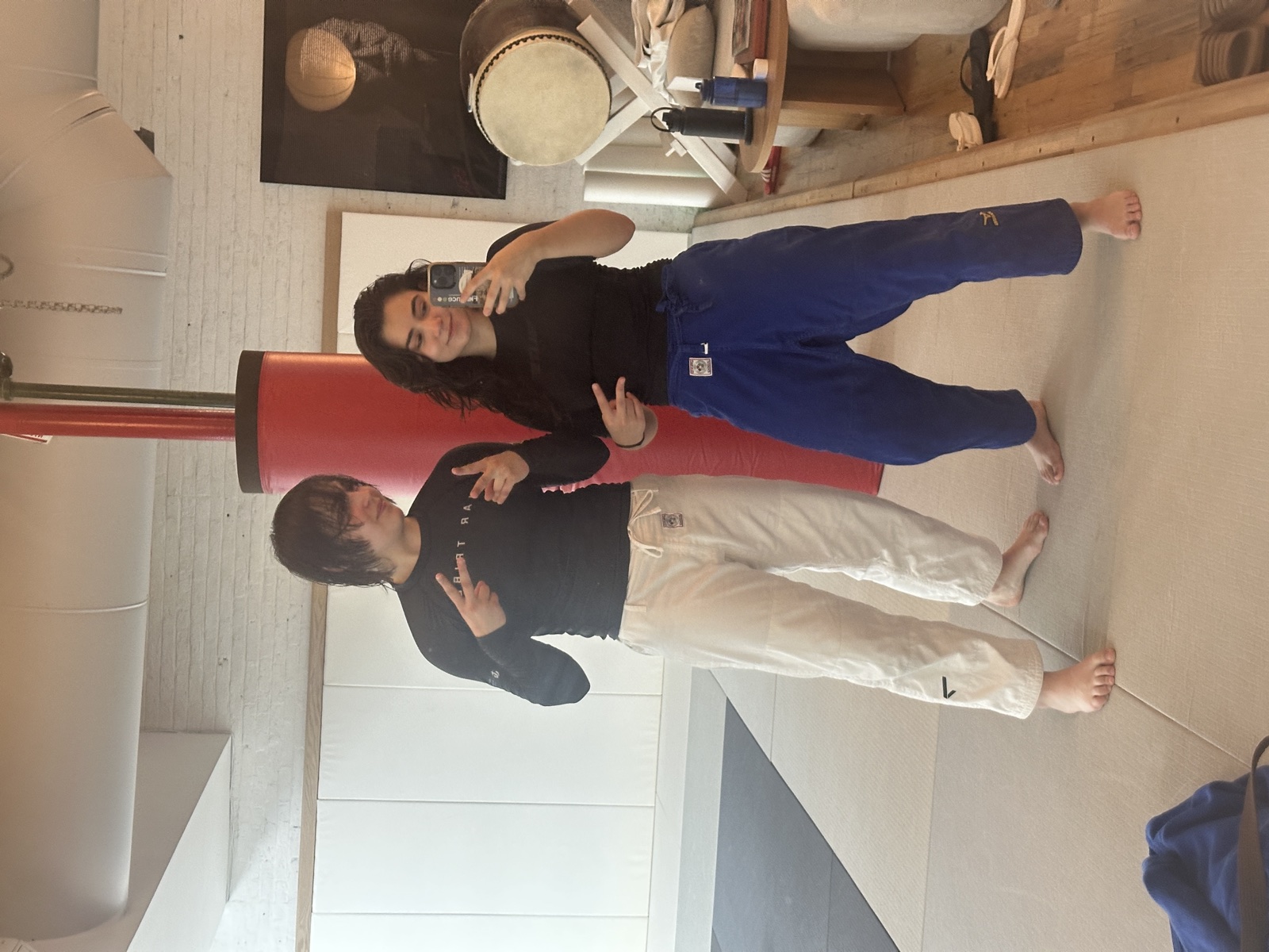 Genevieve and a training partner in judo pants on the dojo mats